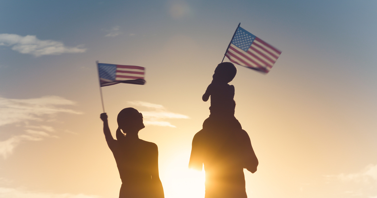 Family waving American flags